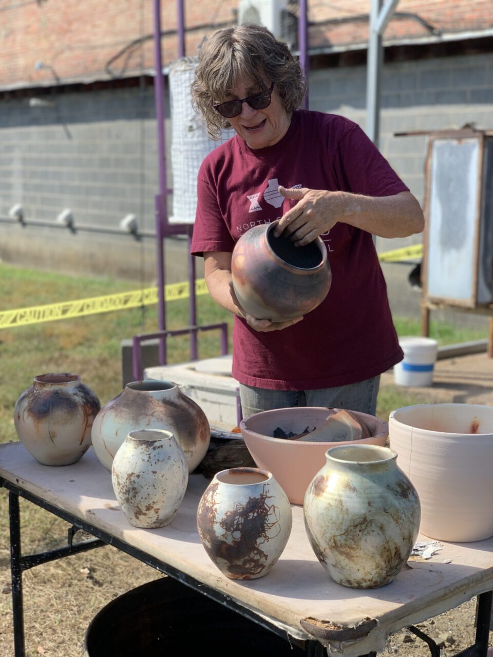 Judi Harwood unwrapping sagger pots Judi Harwood unwrapping sagger pots