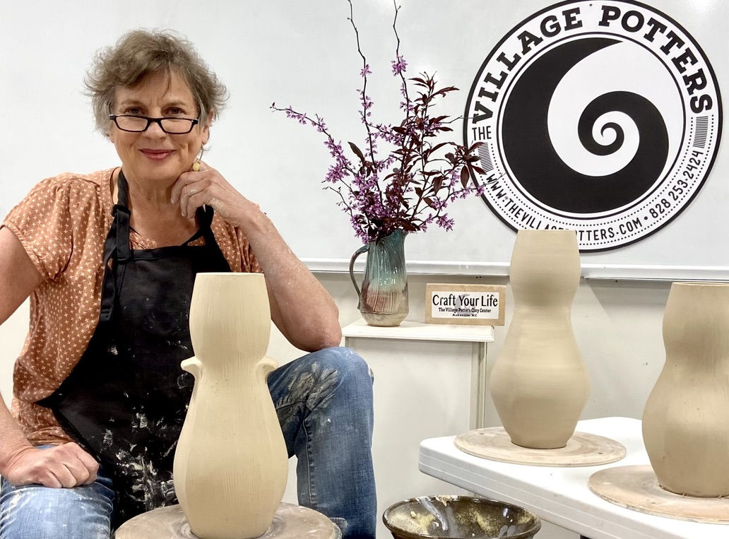 Sarah Wells Rolland sitting with leather hard vases with TVP circular logo Sarah Wells Rolland sitting with leather hard vases with TVP circular logo