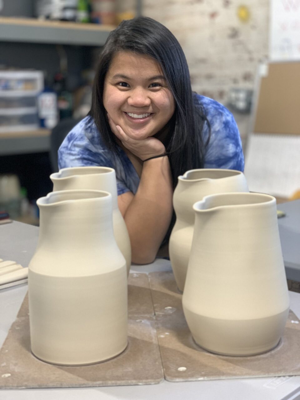 Katie Meili Messersmith, ceramic artist and instructor, with leather hard clay pitchers Katie Meili Messersmith, ceramic artist and instructor, with leather hard clay pitchers