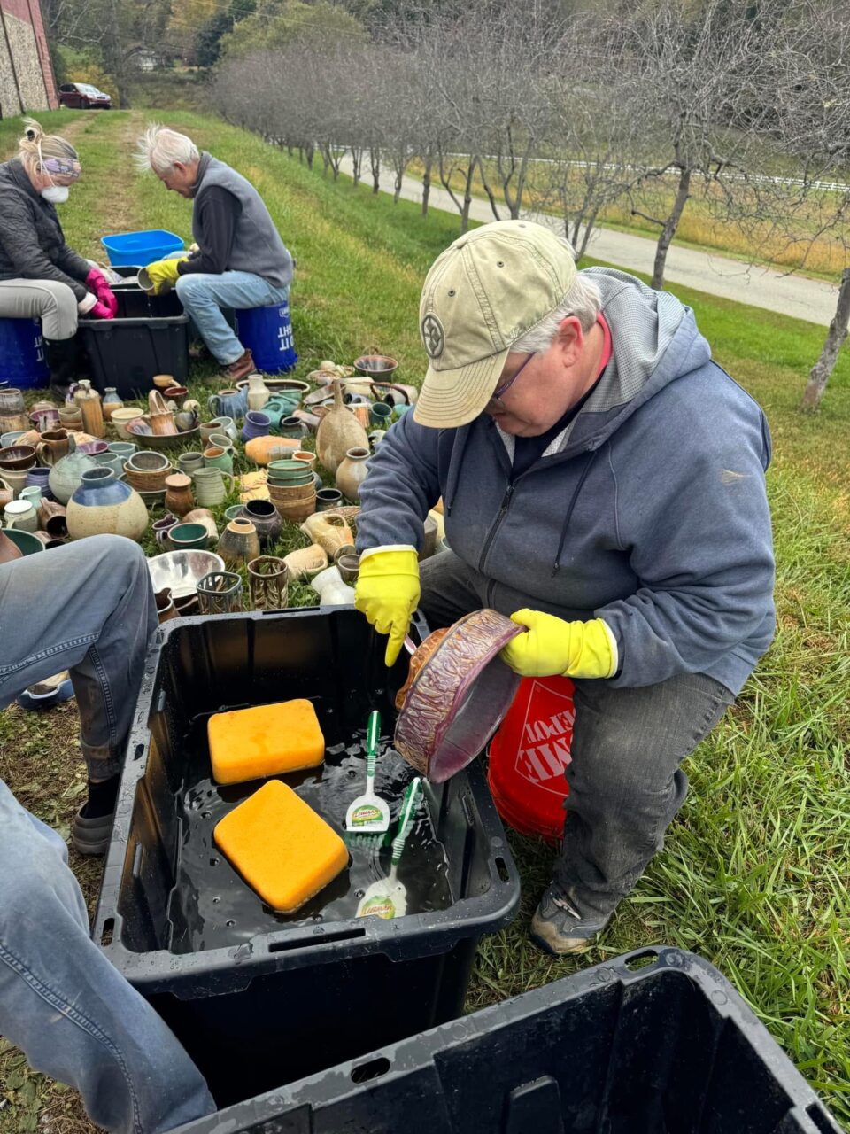 Julia Mann and volunteers washing pots after the flood at the barn 2 Julia Mann and volunteers washing pots after the flood at the barn 2