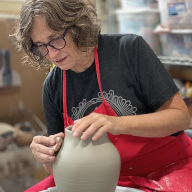 Judi Harwood throwing vase on potters wheel Judi Harwood throwing vase on potters wheel