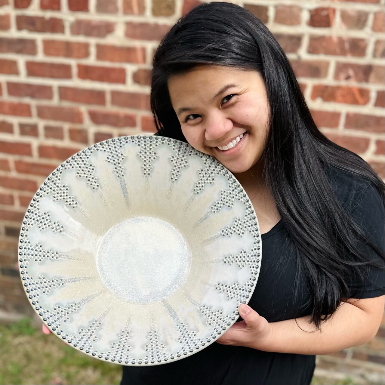 Katie Meili Messersmith holding finish pot, statement bowl, dot pots, infinite cobalt whispers, face close to pot Katie Meili Messersmith holding finish pot, statement bowl, dot pots, infinite cobalt whispers, face close to pot