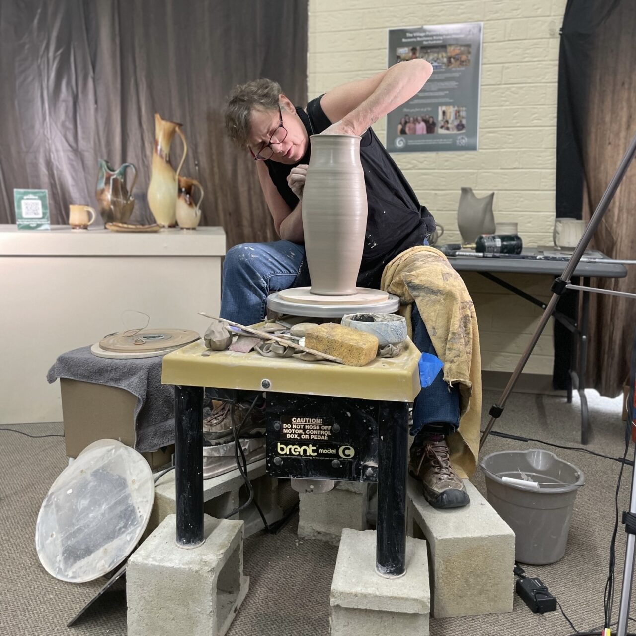 Sarah Wells Rolland throwing on potters wheel on workshop tour, demonstrating Sarah Wells Rolland throwing on potters wheel on workshop tour, demonstrating