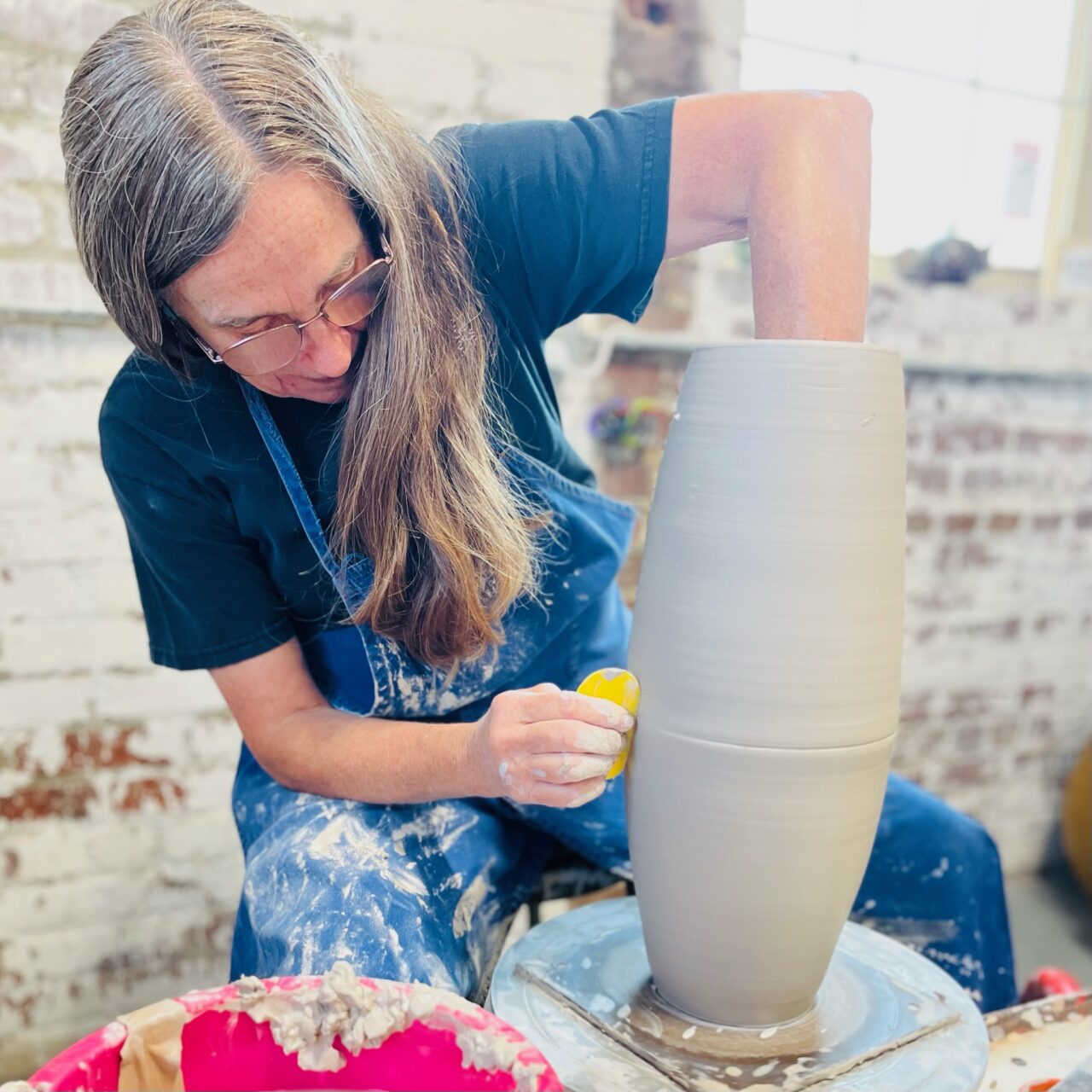 Judi Harwood throwing on the potters wheel, joining seam of sectional pot Judi Harwood throwing on the potters wheel, joining seam of sectional pot