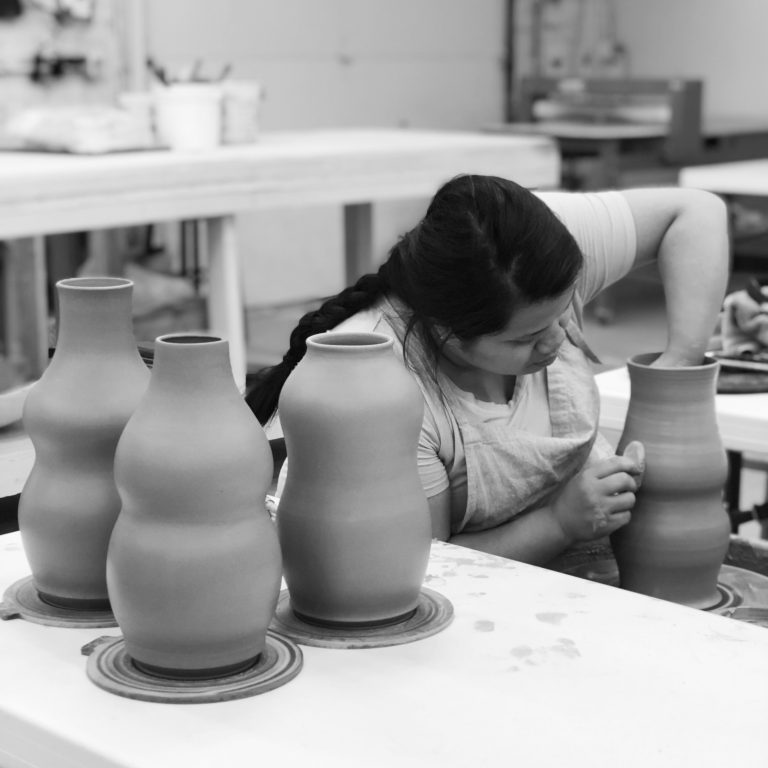 Katie Meili Messersmith throwing vases on the potters wheel in ISM studio Katie Meili Messersmith throwing vases on the potters wheel in ISM studio