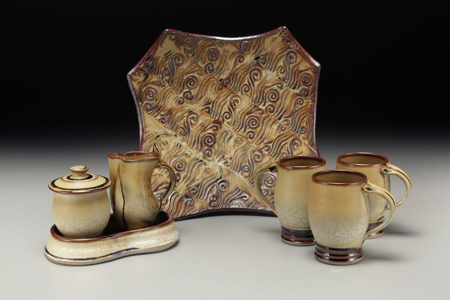 Sarah Wells Rolland finished pots grouping, mugs, jar and creamer set, hand built platter with texture, pumpkin and leach black glaze Sarah Wells Rolland finished pots grouping, mugs, jar and creamer set, hand built platter with texture, pumpkin and leach black glaze
