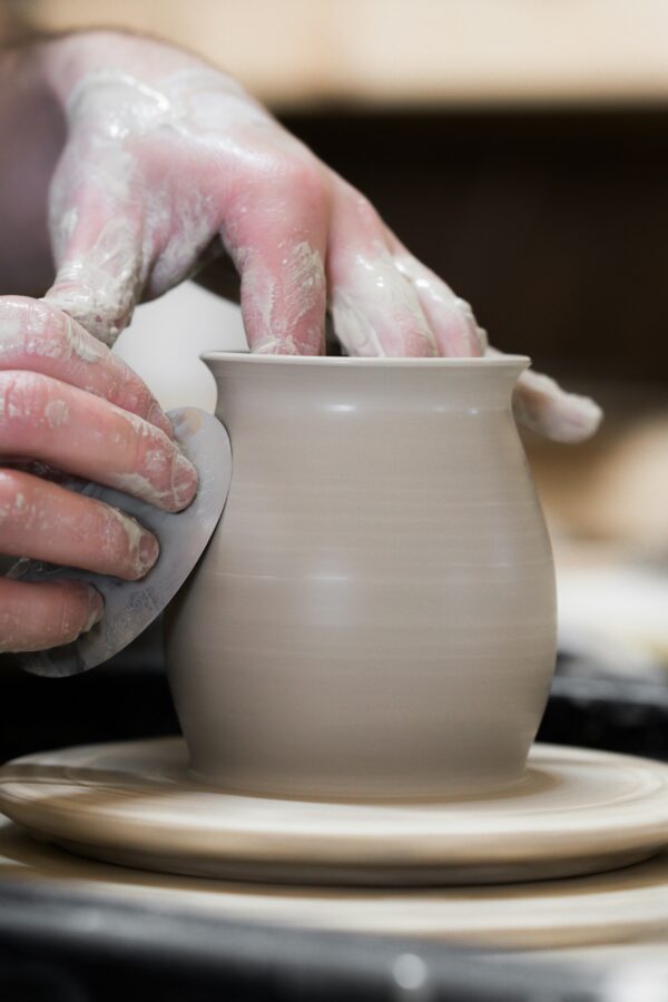 Stock image, Close Up of Hands on Pottery Wheel with Metal Rib