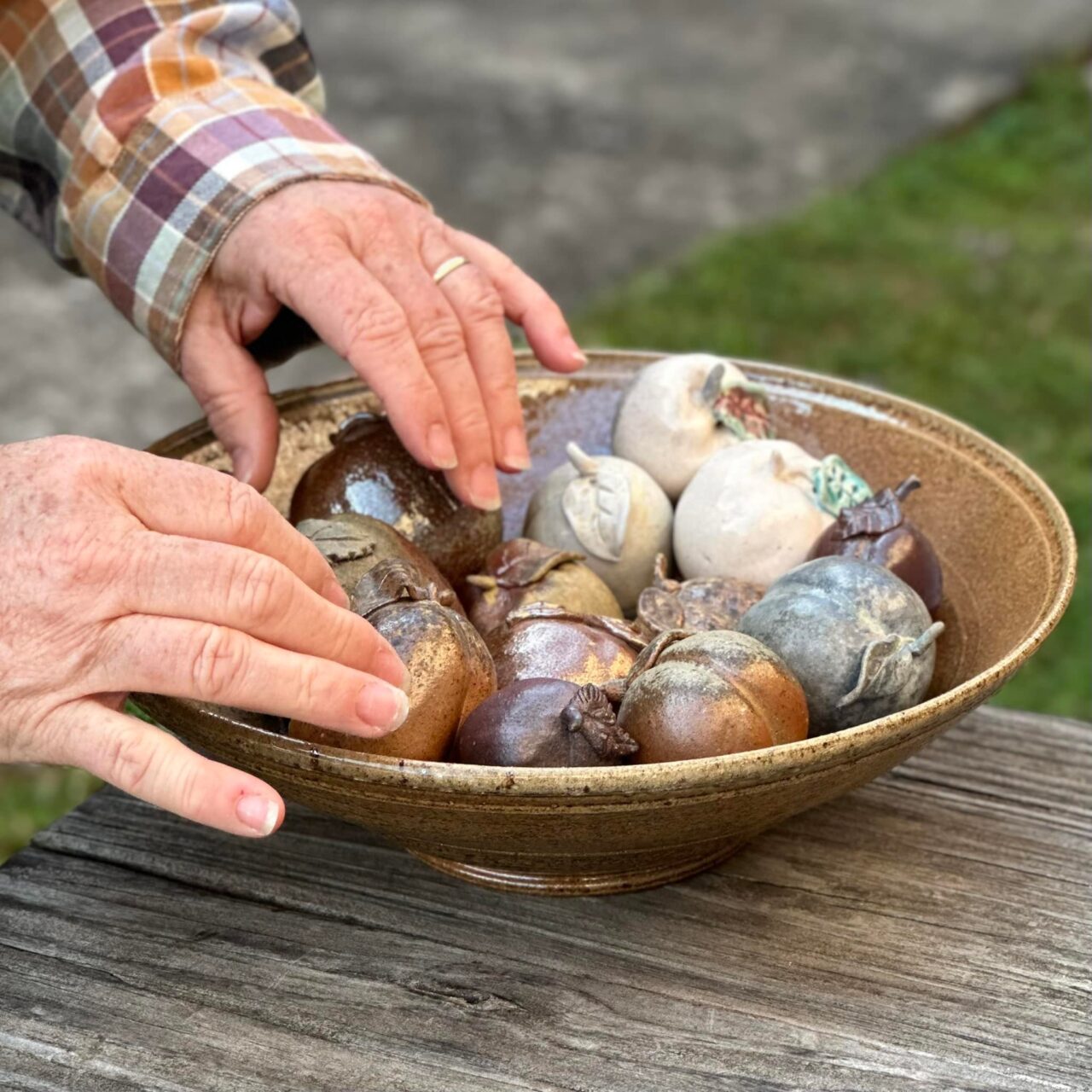Close up of Karen Dubois hands on finished fruit pots in a bowl Close up of Karen Dubois hands on finished fruit pots in a bowl