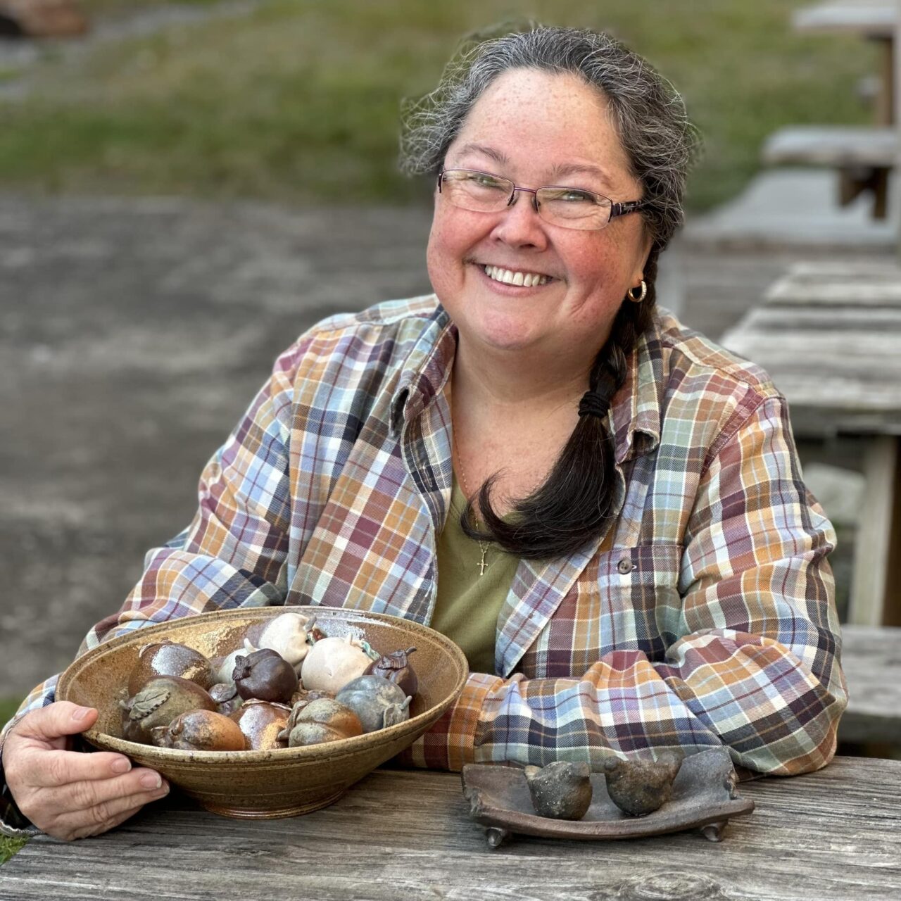 Karen Dubois headshot with finished pots, small fruit Karen Dubois headshot with finished pots, small fruit