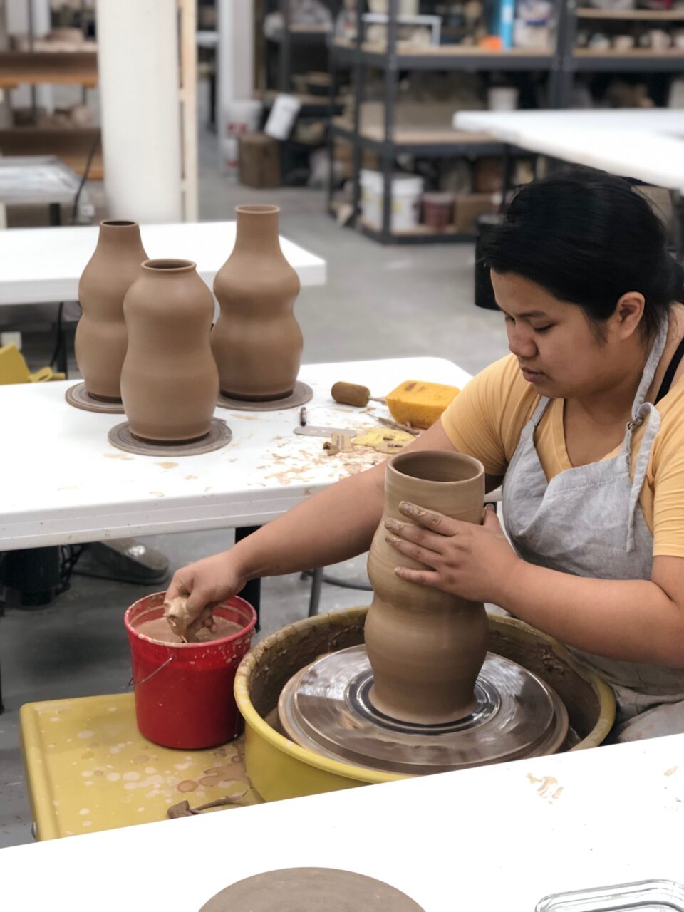 Katie Meili Messersmith fresh thrown vases, red clay, throwing at potters wheel, our stock image, silhouette view 6 Katie Meili Messersmith fresh thrown vases, red clay, throwing at potters wheel, our stock image, silhouette view 6